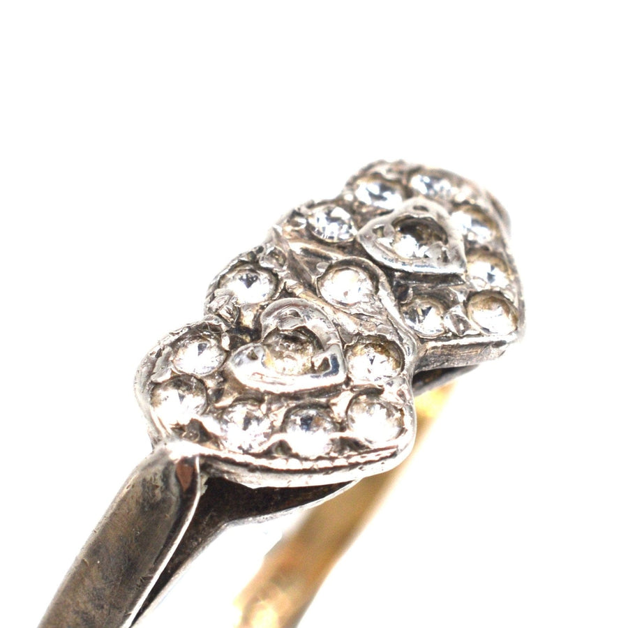 Edwardian 9ct gold and silver double heart paste ring showcasing linked hearts and sparkling stones.
