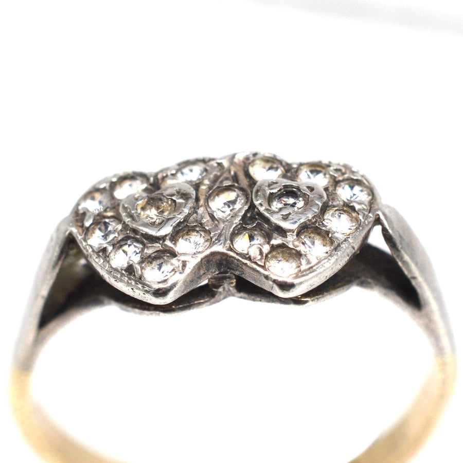 Edwardian 9ct gold and silver double heart ring with paste stones, symbolizing timeless love and elegance.