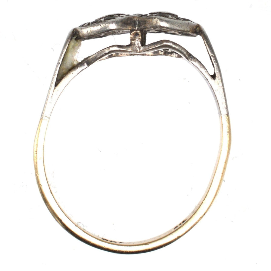 Edwardian 9ct gold and silver double heart ring showing ornate design with paste stones, symbolizing timeless love.