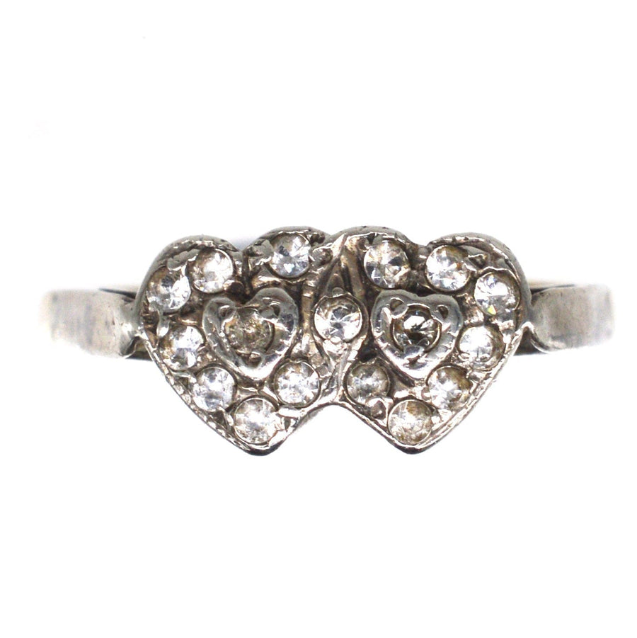 Edwardian 9ct gold and silver double heart ring with paste stones, showcasing sentimental elegance and timeless design.