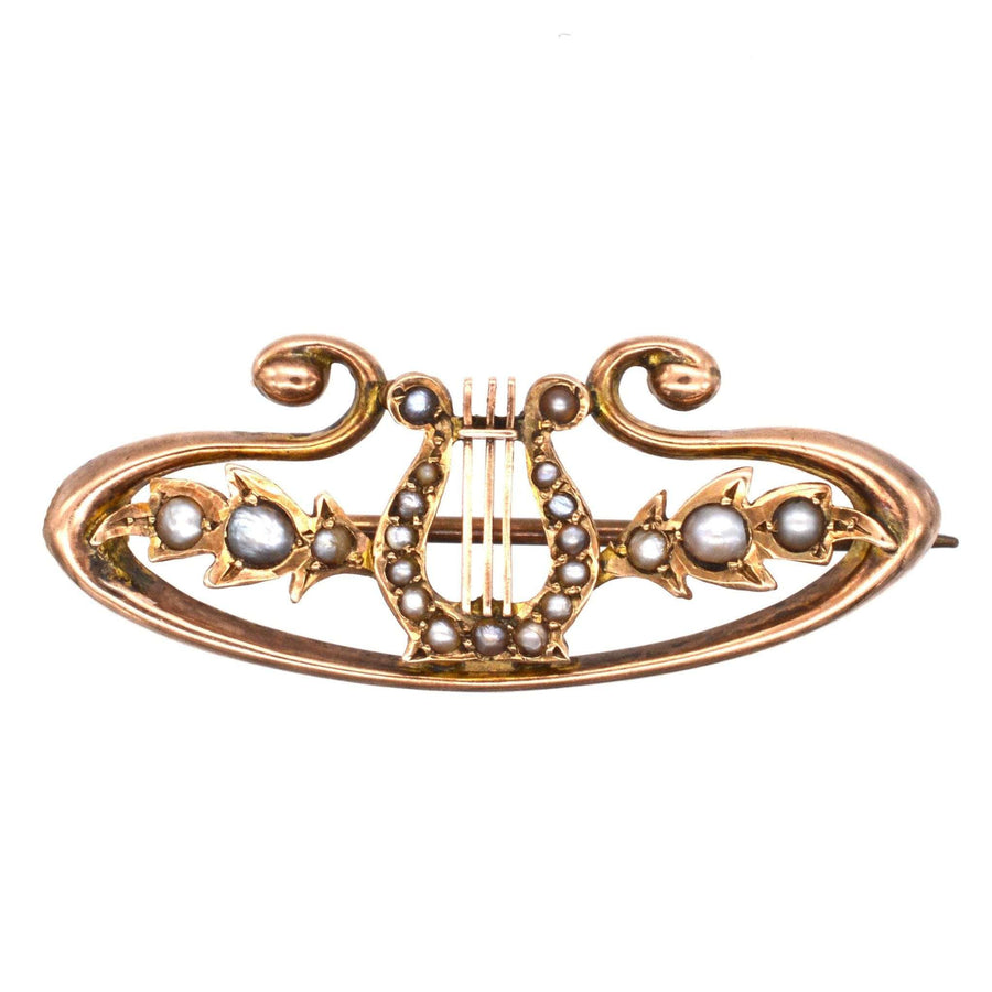 9ct gold lyre bar brooch adorned with split pearls and elegant scroll details, symbolizing music and heavenly love.