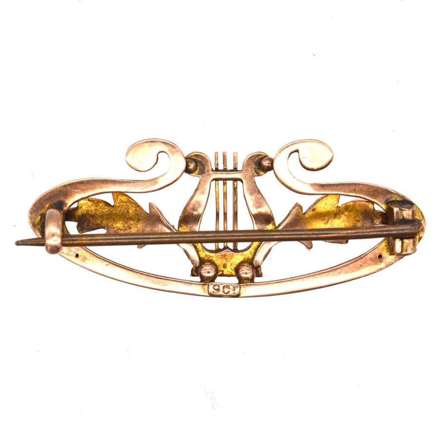 Edwardian 9ct gold lyre bar brooch with split pearls and elegant scroll details, symbolizing music and love.