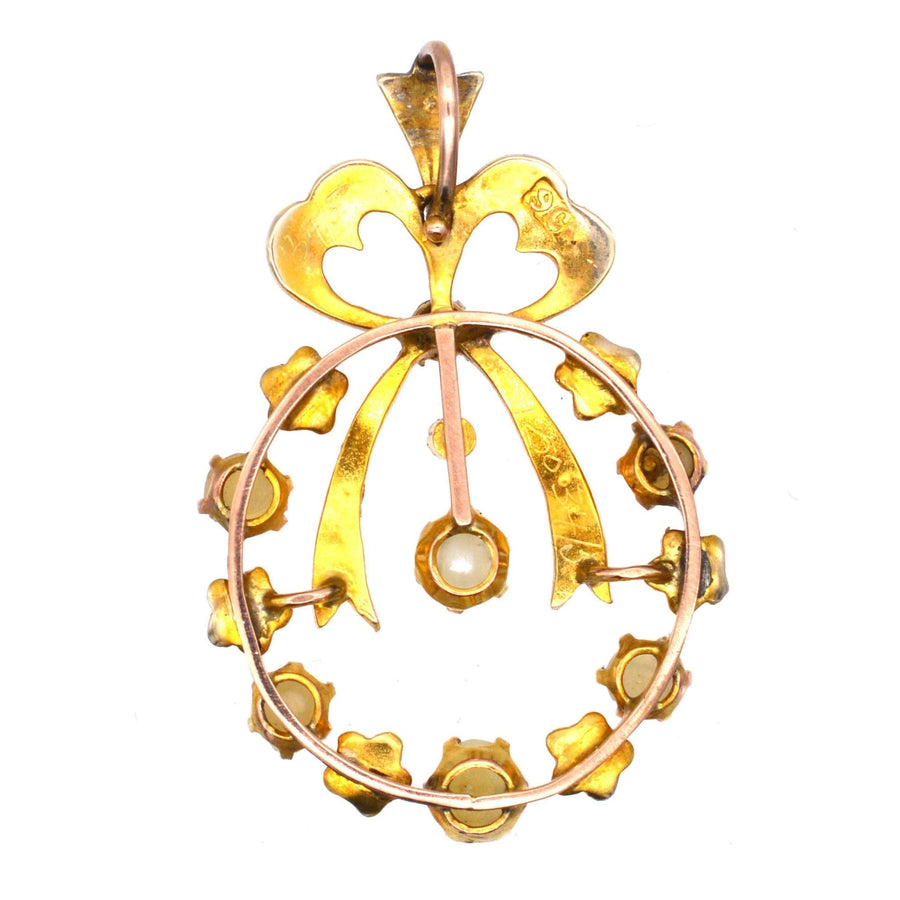 Edwardian 9ct gold pendant featuring split pearls and bow motif, inspired by 18th century designs.