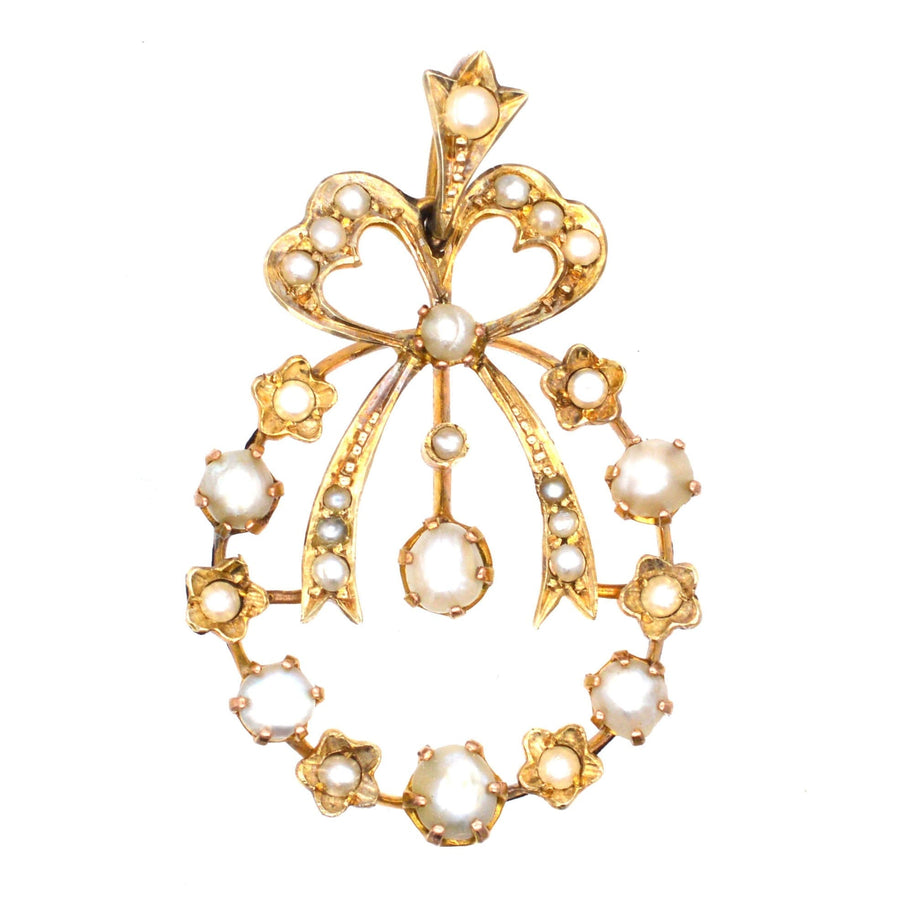 Edwardian 9ct gold pendant featuring split pearls and bow motif, inspired by 18th century garland designs.