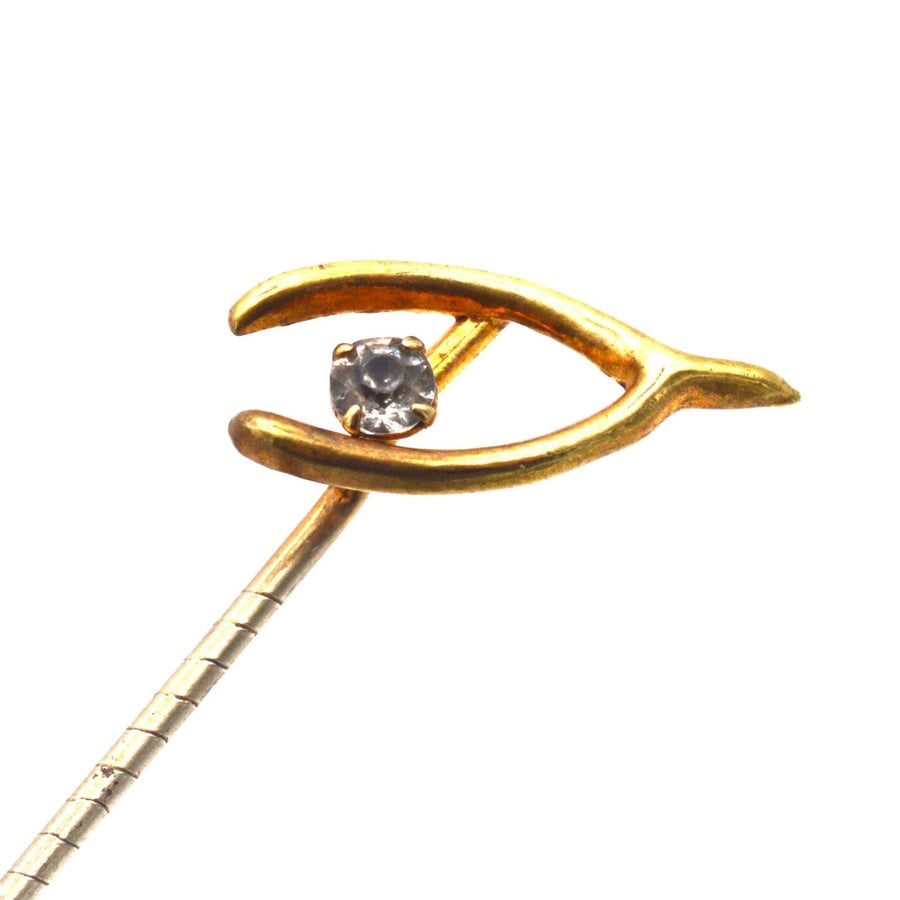 Edwardian 9ct gold wishbone tie pin featuring a sparkling white paste stone for good luck.