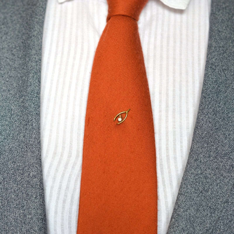 Edwardian 9ct gold wishbone pin on a tie, symbolizing love and good fortune.