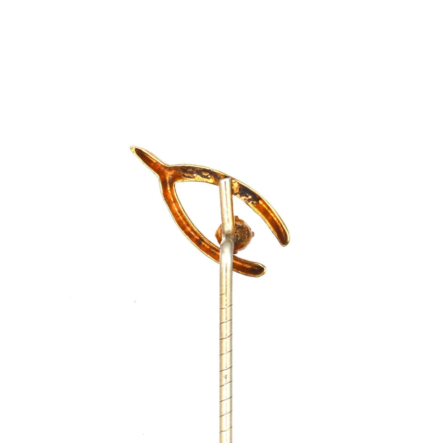 Edwardian 9ct gold wishbone tie pin with white paste, symbolizing love and good fortune.