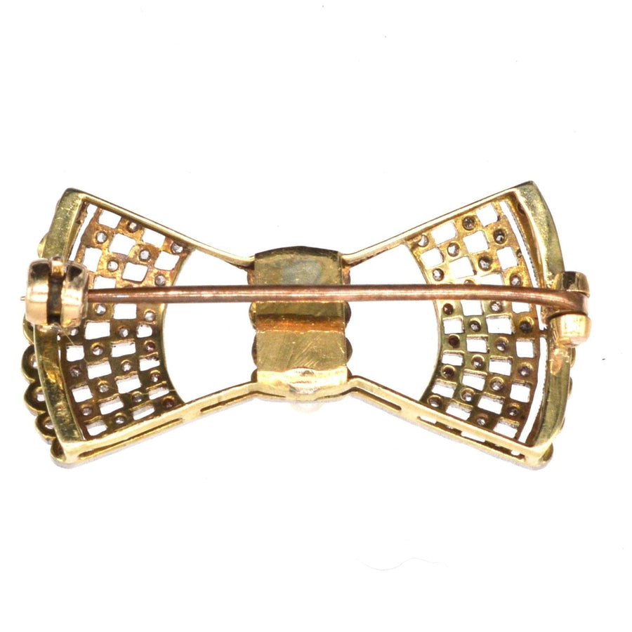 Edwardian 18ct gold and platinum lace bow brooch with sparkling diamonds and intricate fretwork design.