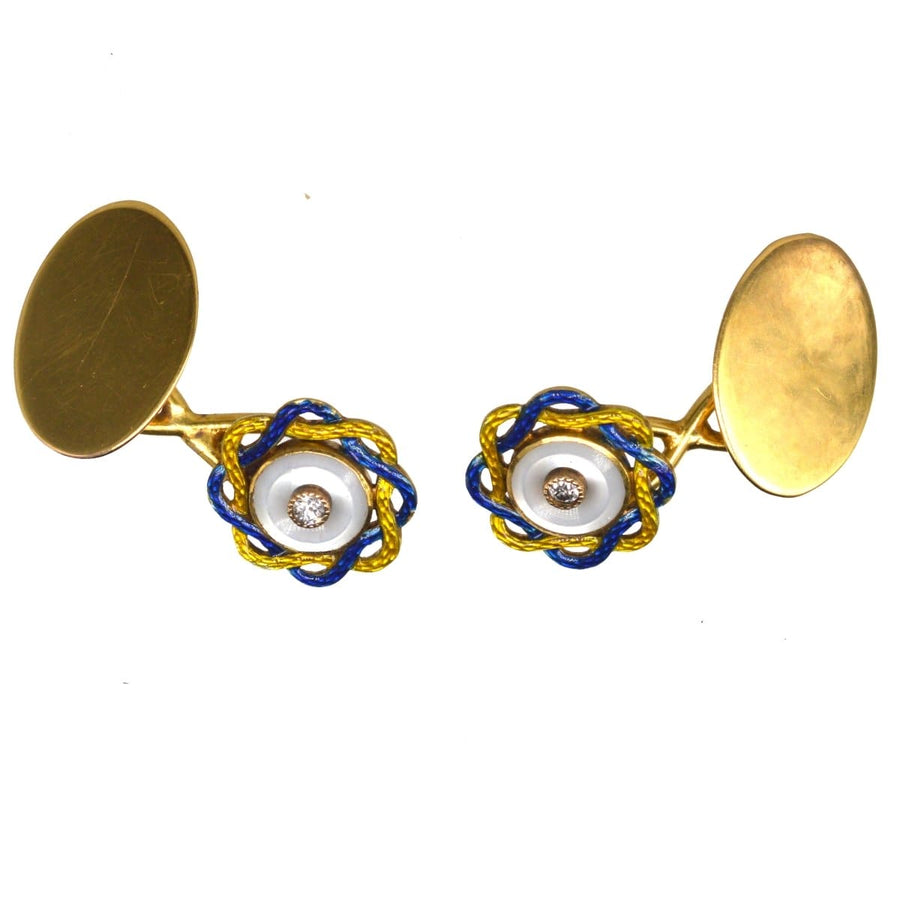 Antique Edwardian cufflinks featuring mother of pearl, diamond center, and vibrant yellow and blue enamel design.