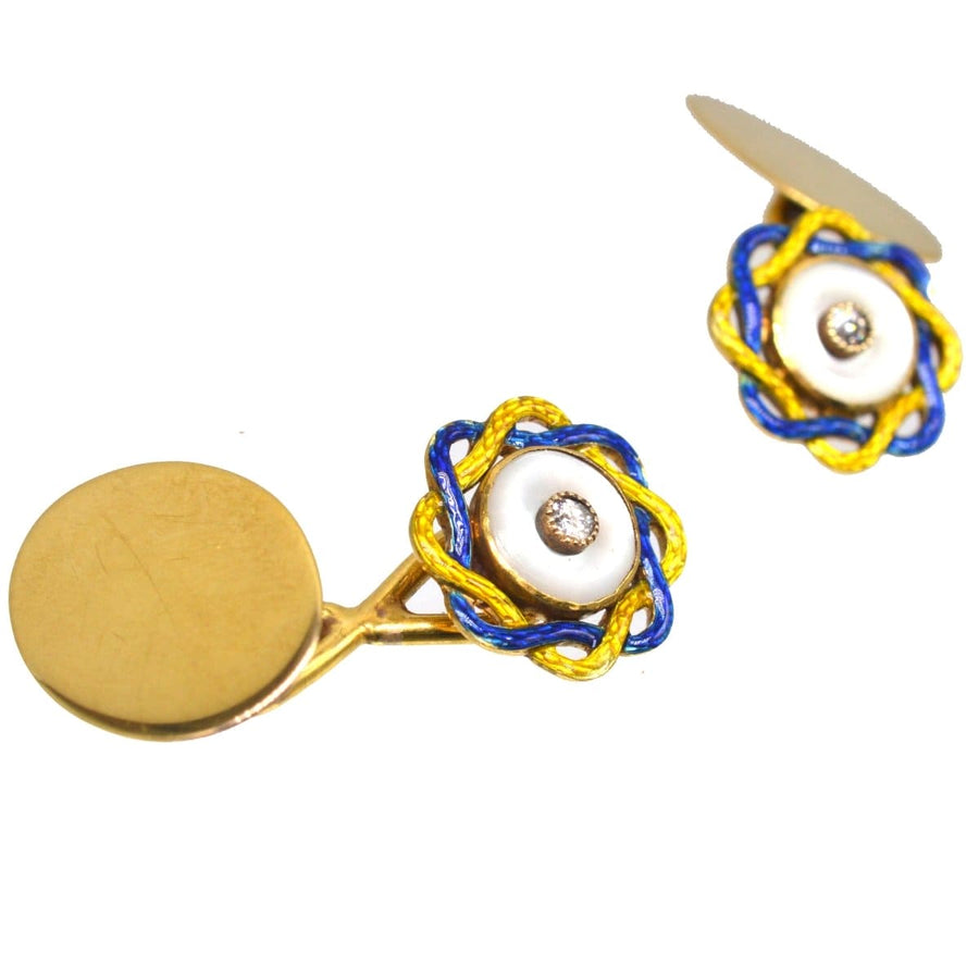 Elegant Edwardian cufflinks featuring mother of pearl discs, diamond centers, and vibrant yellow and blue enamel rope.