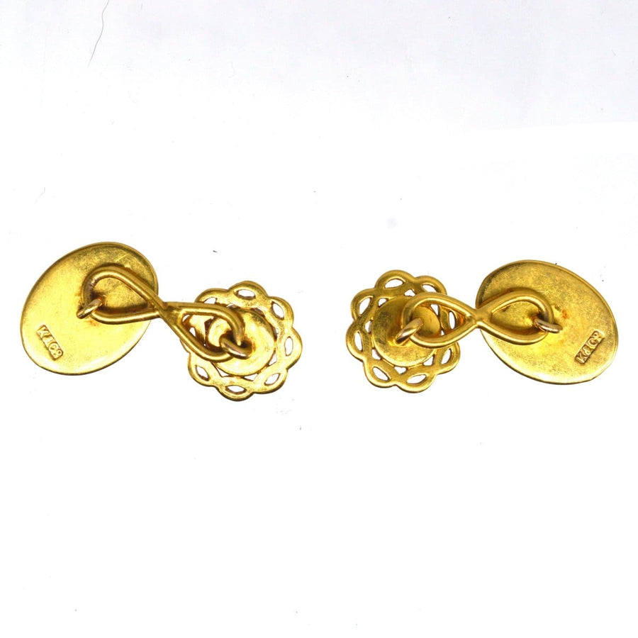 Antique gold cufflinks featuring intricate designs, showcasing craftsmanship and elegance.