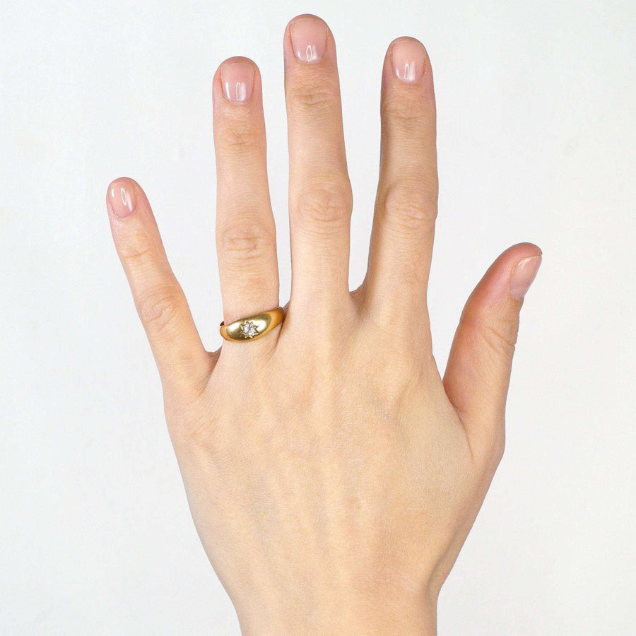 Edwardian 18ct gold gypsy ring with old mine cut diamond on a model's hand.