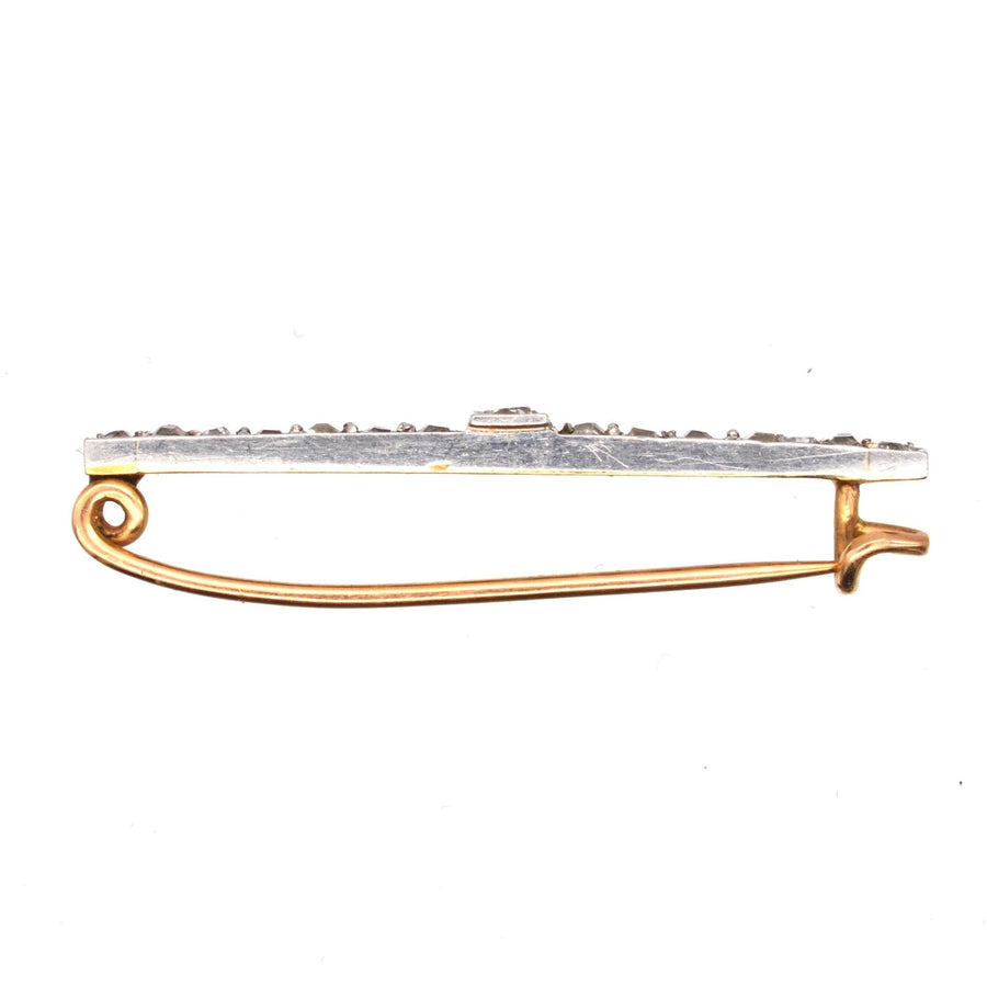 Edwardian platinum and 15ct gold bar brooch featuring old mine cut diamonds, perfect for dresses or ties.