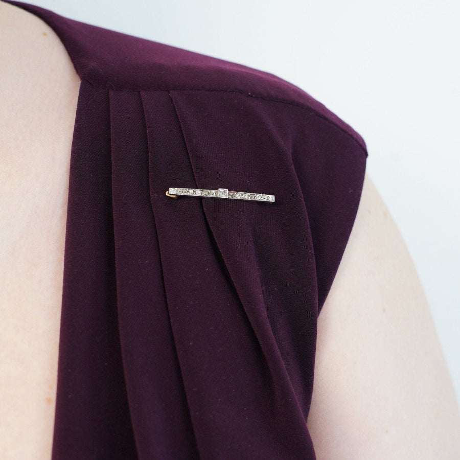Stylish Edwardian platinum and 15ct gold bar brooch with old mine cut diamonds on a purple dress.