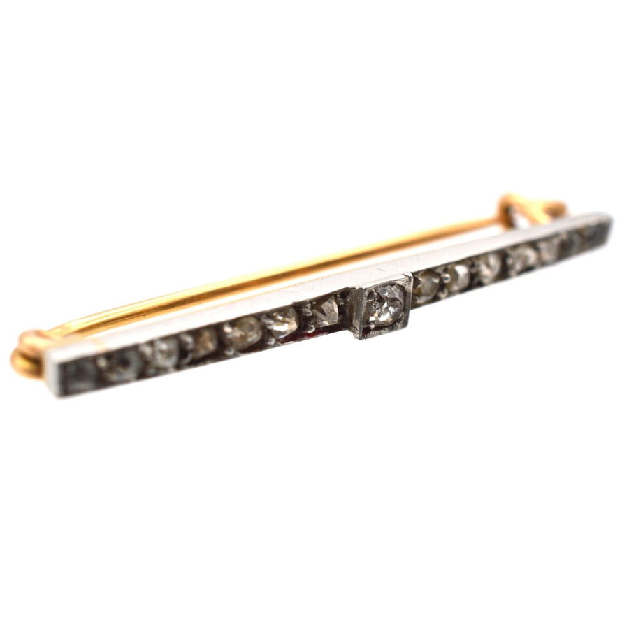 Edwardian platinum and 15ct gold brooch featuring old mine cut diamonds, stylish for both dresses and ties.