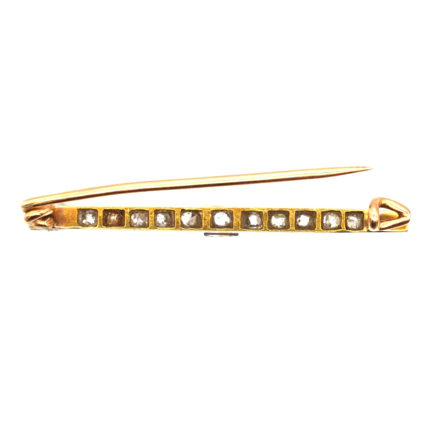 Edwardian platinum and 15ct gold bar brooch with old mine cut diamonds, perfect for dresses or ties.