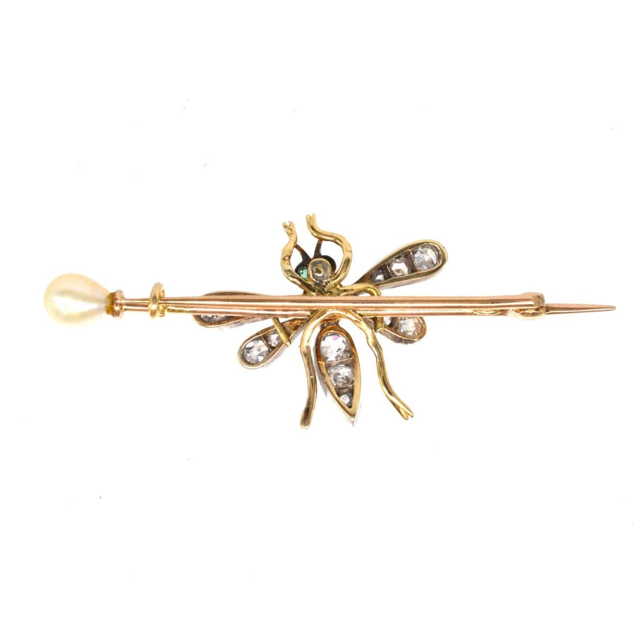 Edwardian bug brooch in platinum and gold, featuring pink sapphire, emerald eyes, diamond wings, and a natural pearl.