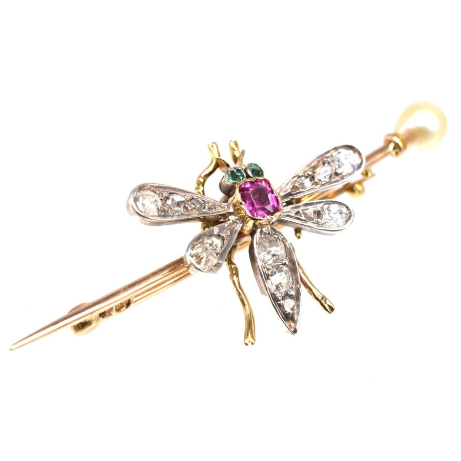 Edwardian bug brooch featuring pink sapphire, emerald eyes, diamond wings, gold pin, and natural pearl accent.