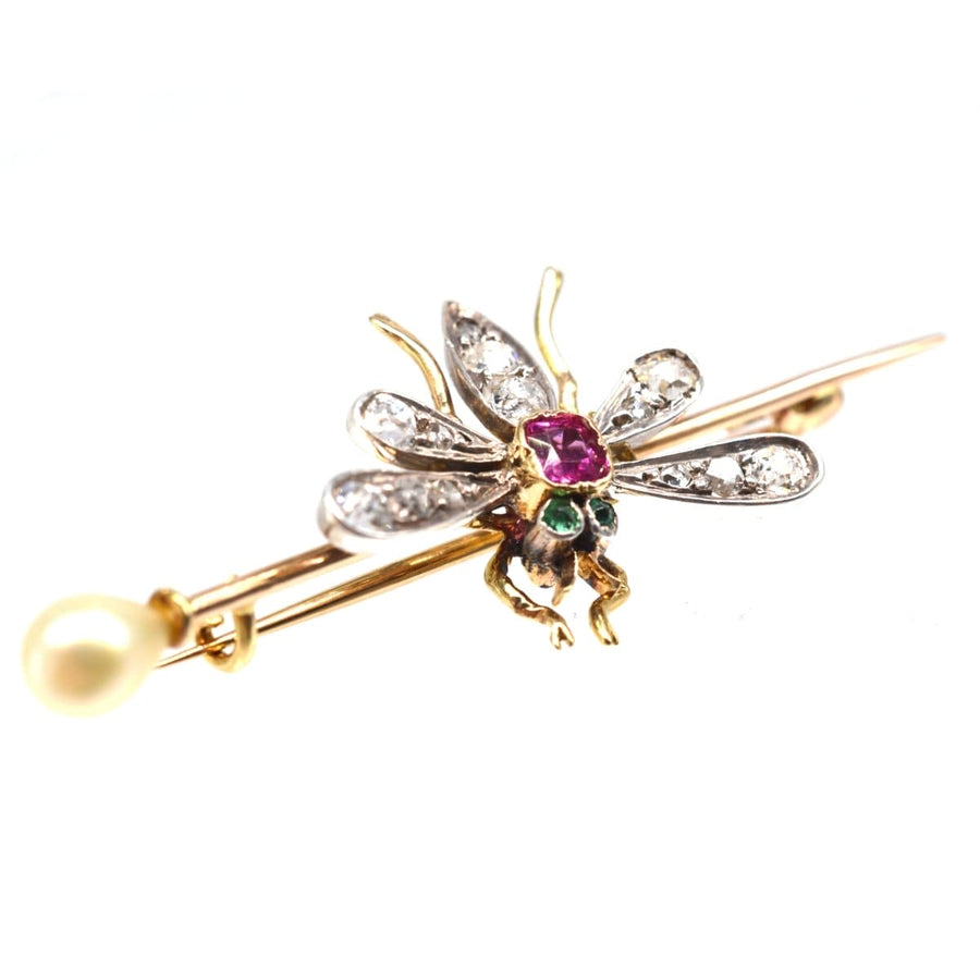 Edwardian platinum and gold bug brooch with pink sapphire, emerald eyes, diamond wings, and natural pearl detail.