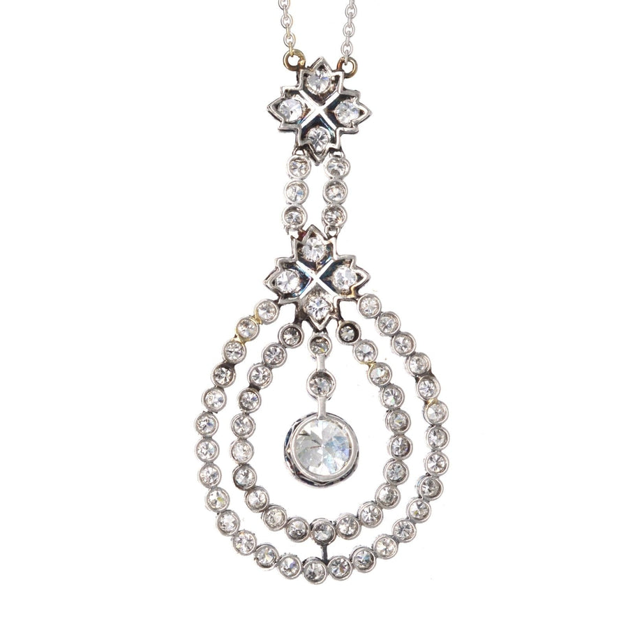 Edwardian platinum pendant featuring 1.3 carat diamond and 63 smaller diamonds on white gold chain.