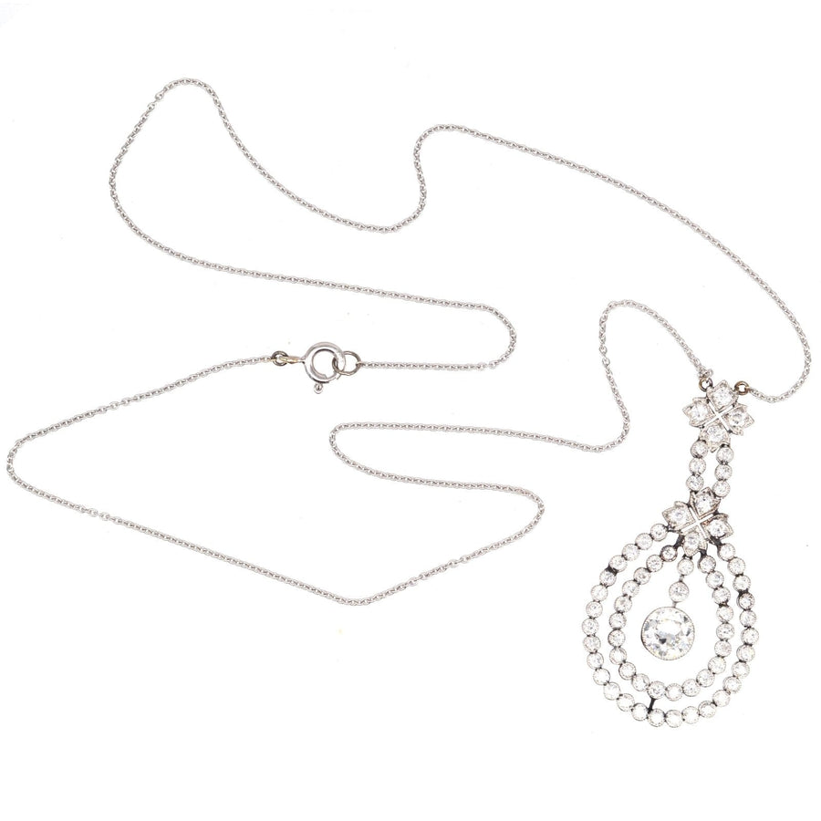 Edwardian platinum pendant showcasing a large diamond, suspended from a delicate 18ct white gold chain.
