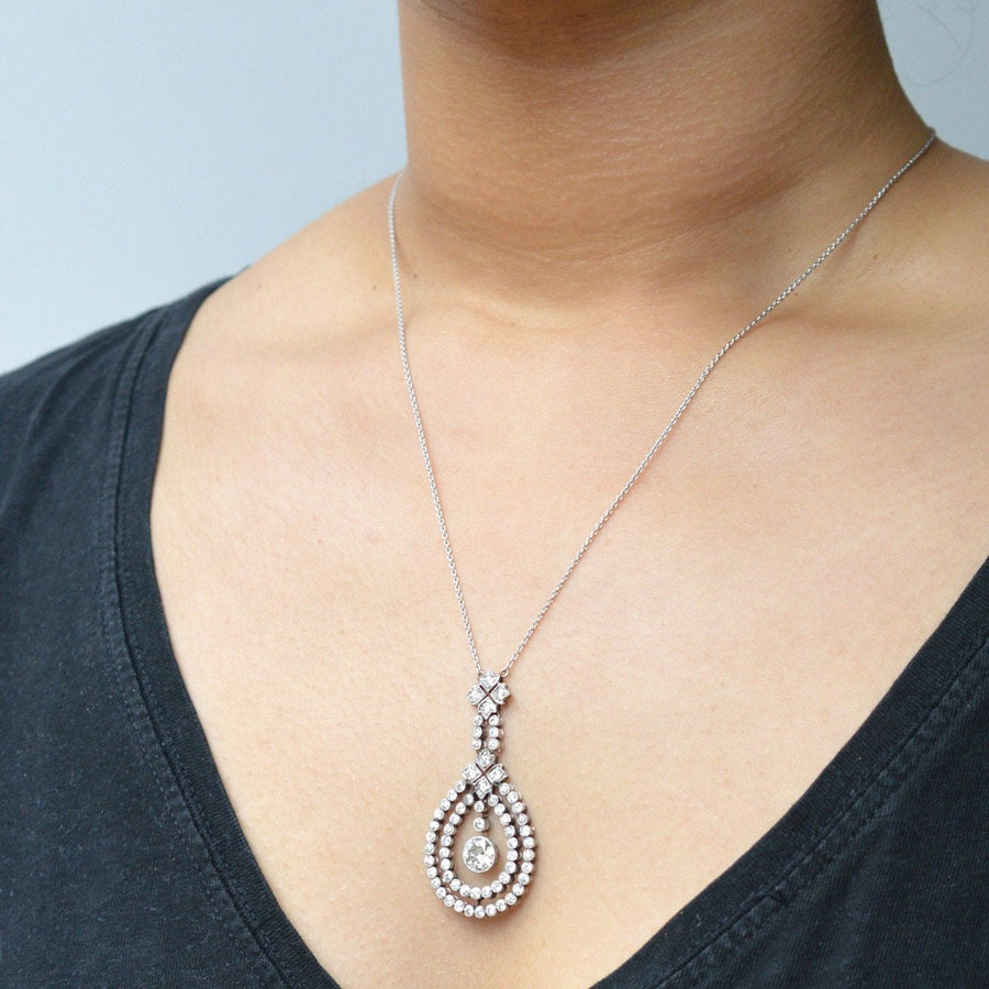Edwardian platinum pendant with 4 carat diamond, worn on an 18ct white gold chain, highlighting intricate design.