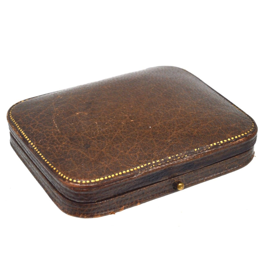 Antique brown leather case with gold detailing, perfect for storing jewelry or delicate items.