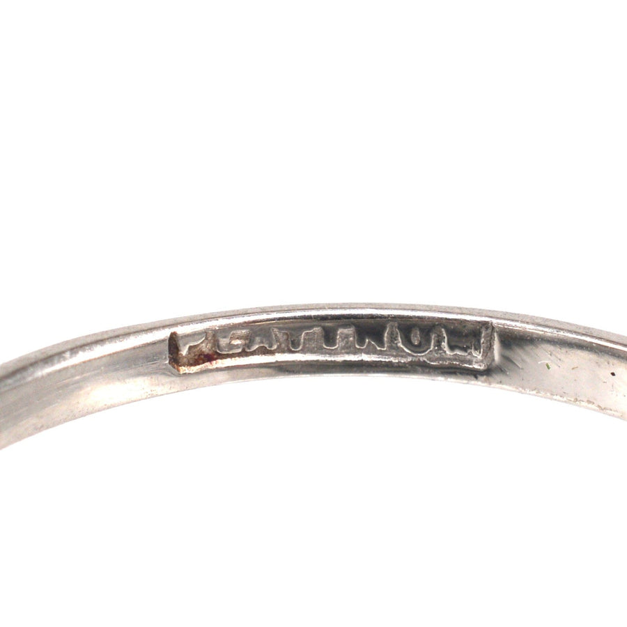 Close-up of the inner band engraving on an Edwardian platinum crossover ring.