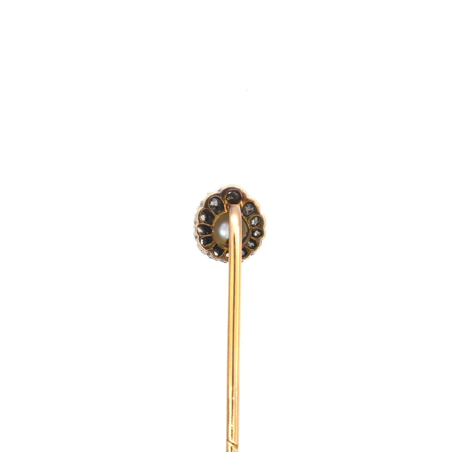 Edwardian silver and gold tie pin featuring a natural pearl and old mine cut diamond cluster.