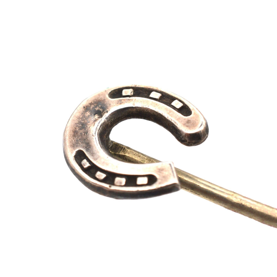 Edwardian silver horseshoe tie pin symbolizing good luck and protection, crafted in the 1900s.
