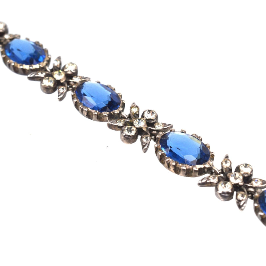 Edwardian silver bracelet featuring vibrant sapphire blue and white paste stones, creating a stunning vintage accessory.