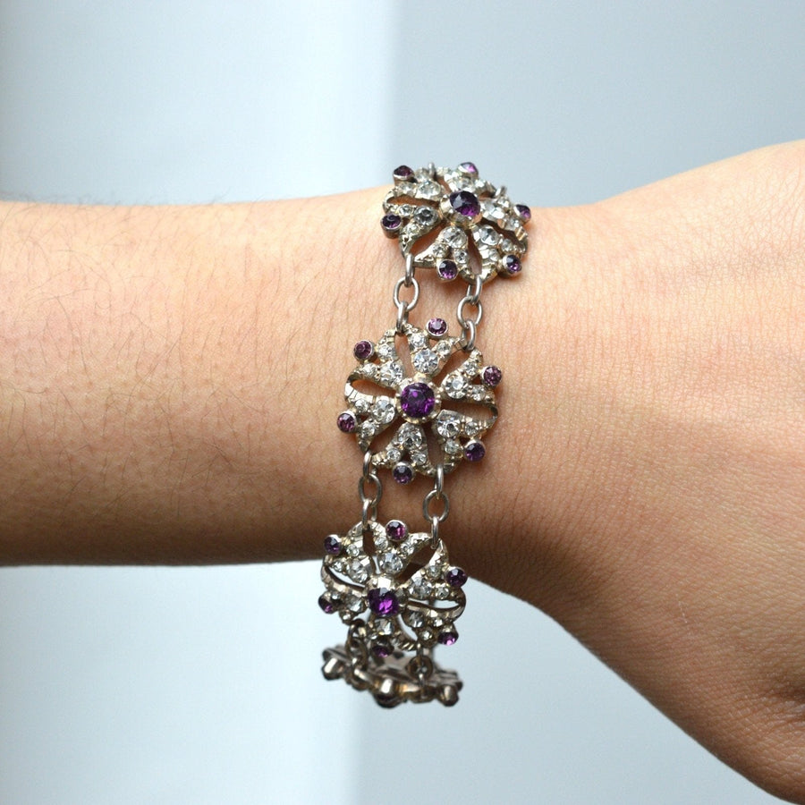 Edwardian white and purple paste floral cluster bracelet on wrist with diamond and amethyst stones.