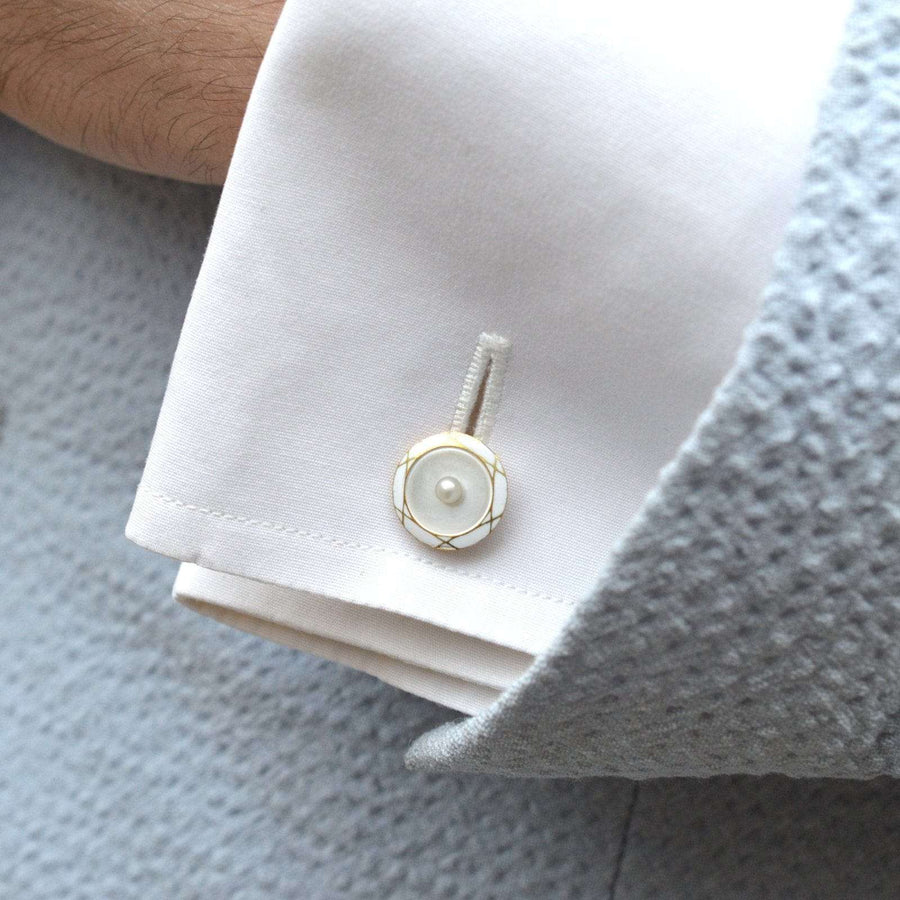 French 18ct gold cufflinks featuring a pearl and mother of pearl design on a crisp white shirt cuff.