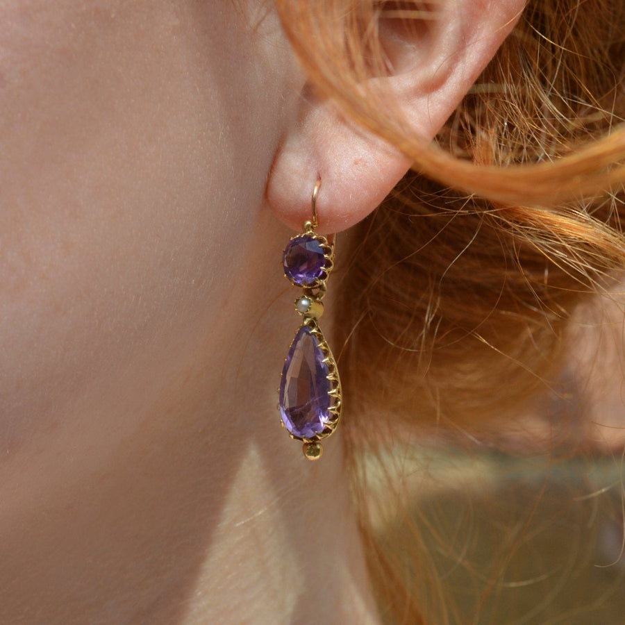 19th century gold earrings featuring amethyst and split pearls, showcasing royal purple hues and vintage design.