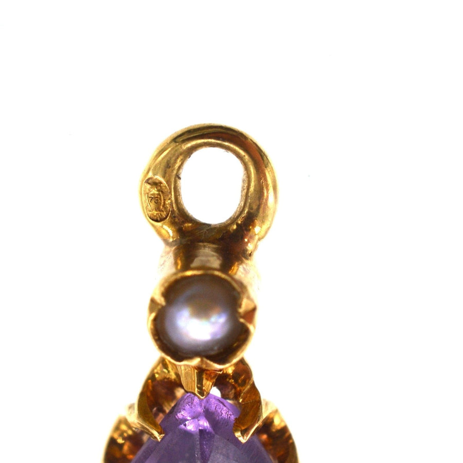 Close-up of a gold earring setting featuring an amethyst and natural split pearl, showing intricate 19th-century design.