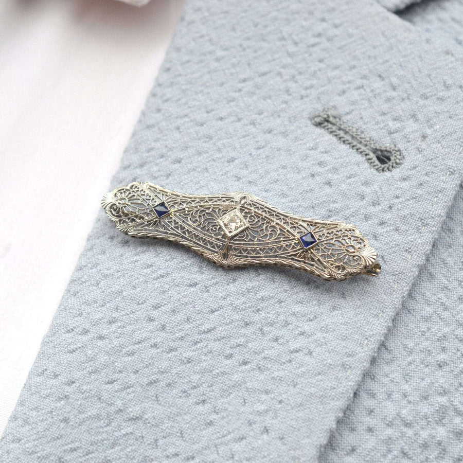 French Art Deco 14ct gold brooch with sapphire and diamond on a lapel. Elegant white gold tracery design with hearts.