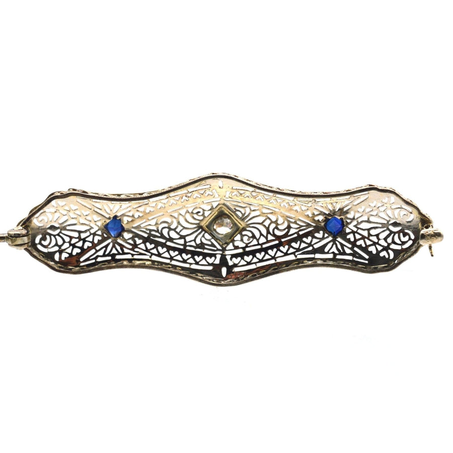 French Art Deco 14ct gold brooch with sapphire and diamond accents, featuring intricate white gold tracery.