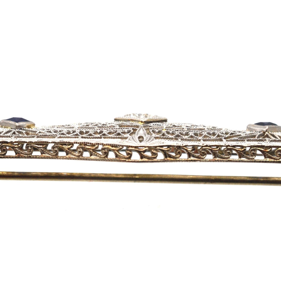 French Art Deco 14ct gold bar brooch featuring sapphires and diamond in delicate white gold tracery.