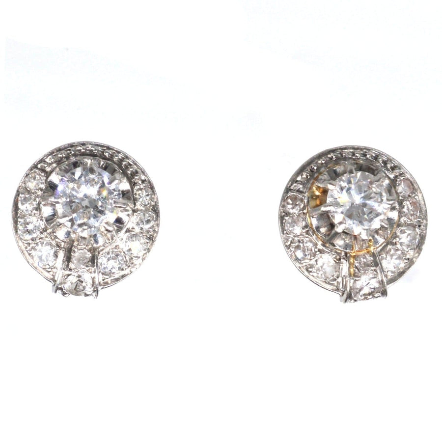 French Art Deco 18ct white gold diamond cluster stud earrings featuring a 0.40 carat diamond surrounded by smaller diamonds.