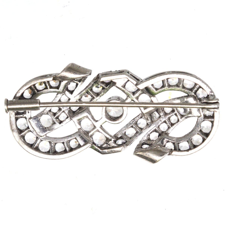 French Art Deco silver paste brooch featuring geometric designs, reflecting light like diamonds, from the 1930s-1940s.