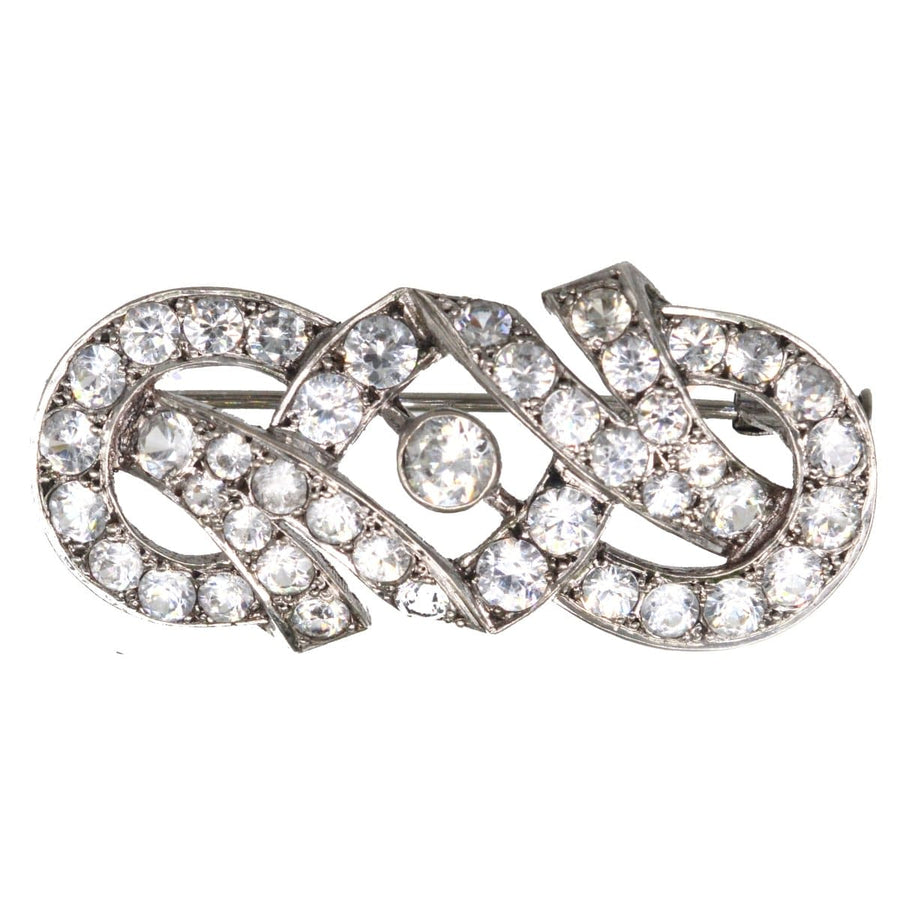 French Art Deco silver paste brooch with geometric design, resembling diamonds, perfect for any lapel.