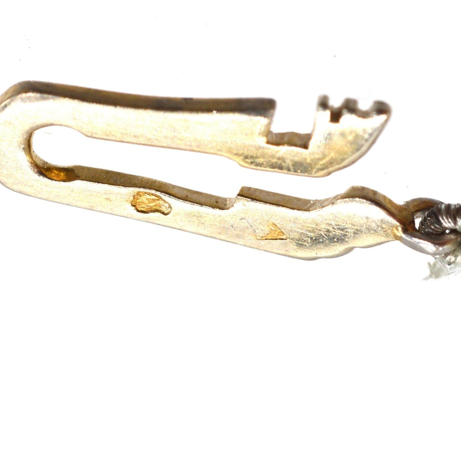 Close-up of a vintage gold necklace clasp, featuring an intricate design showcasing timeless elegance.