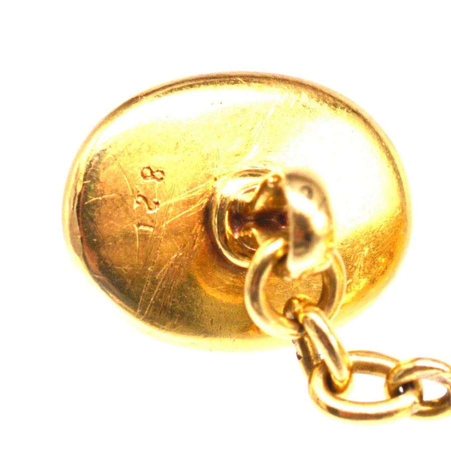 Back view of 18ct gold cufflink showing hallmarks and fastening mechanism.