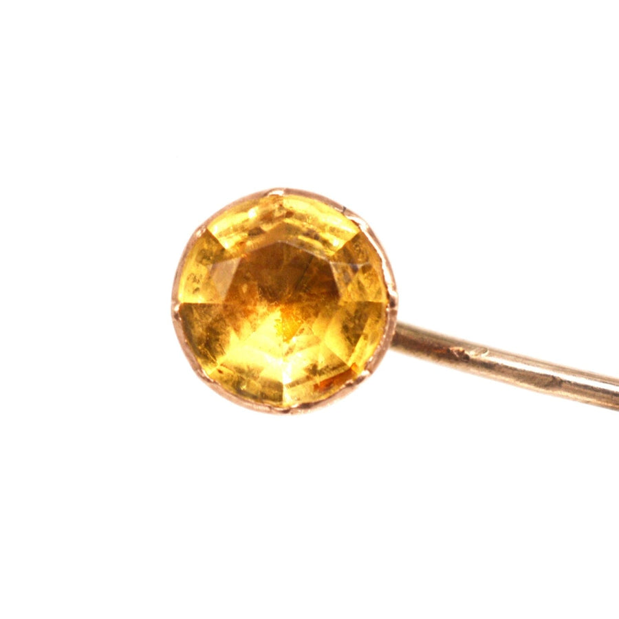 Close-up of a Georgian 9ct gold tie pin featuring a faceted citrine gemstone, perfect for silk ties.