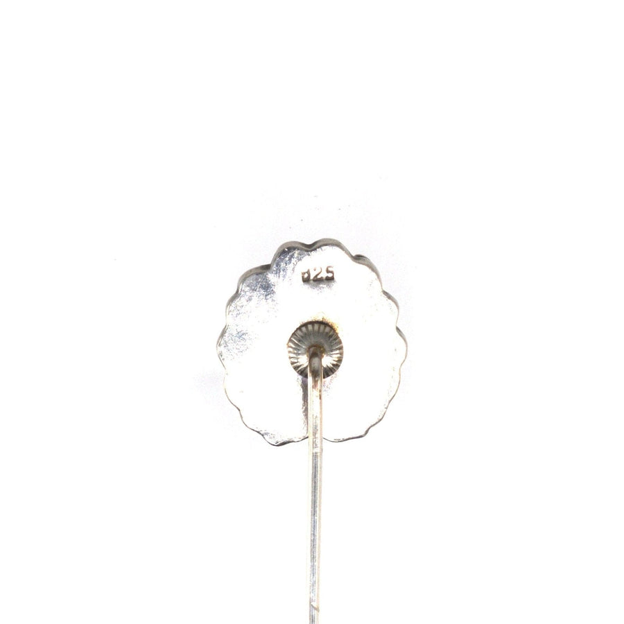 Back view of a vintage 1940s silver tie pin, featuring a scalloped design and a secure pin mechanism.