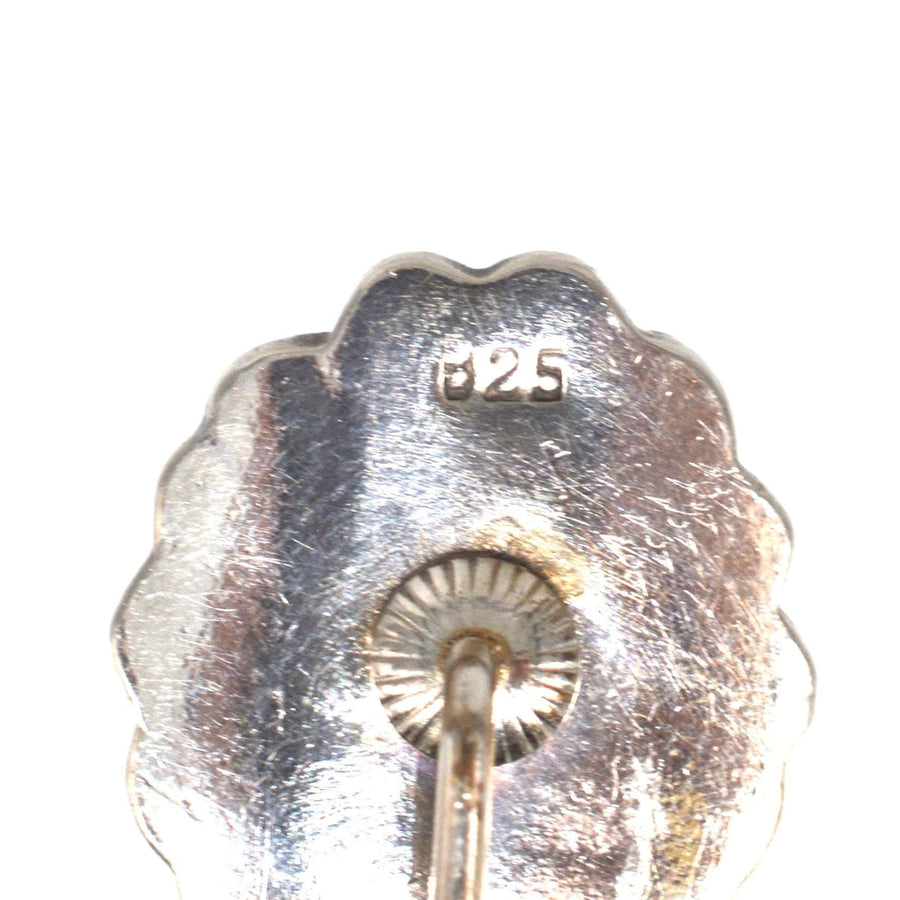 Close-up of the back of a vintage silver tie pin showing the 925 mark for sterling silver quality.