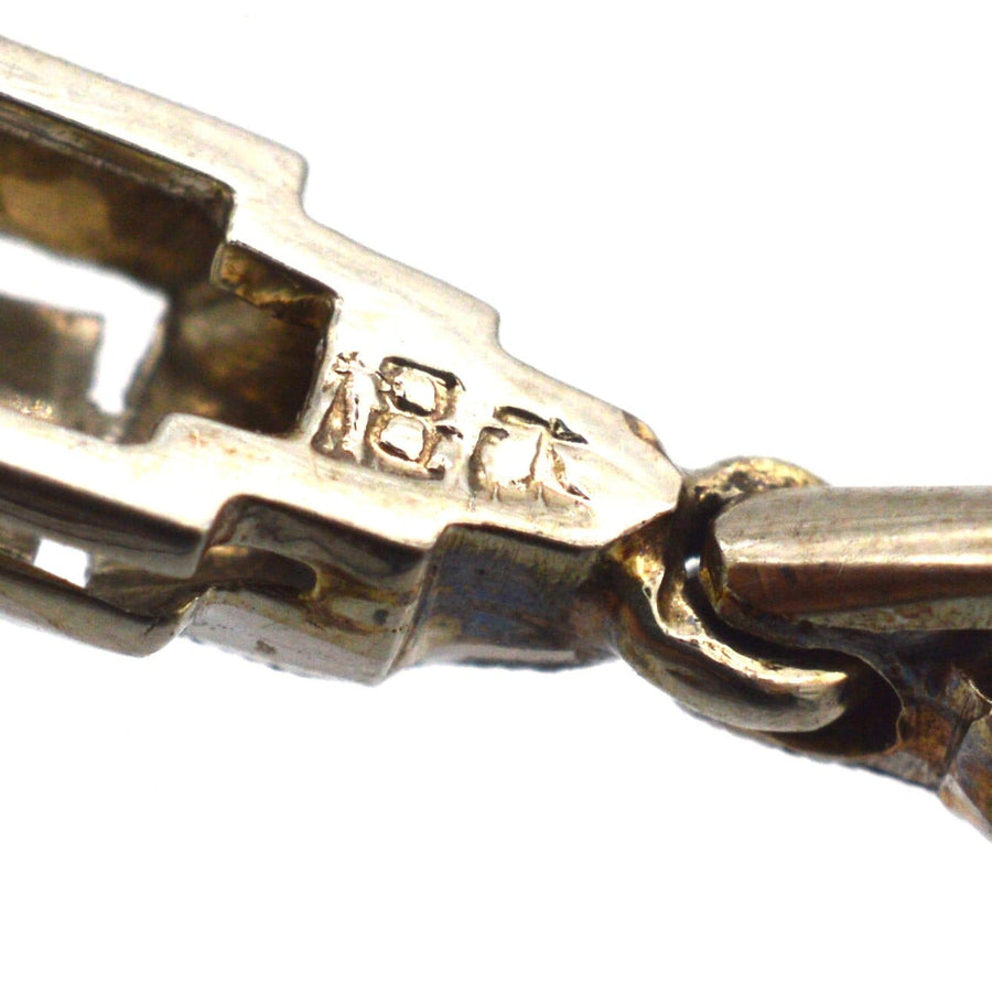 Close-up of 18ct gold pendant clasp showcasing hallmark detail and craftsmanship.