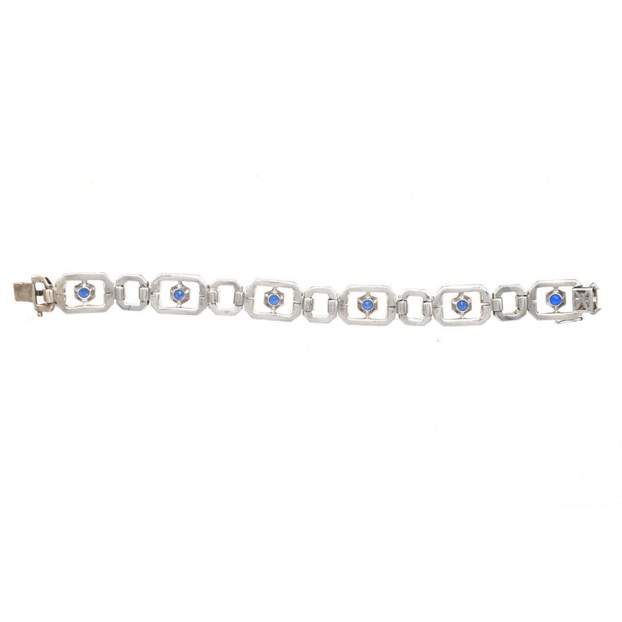 Art Deco silver bracelet featuring blue paste "sapphires" and white paste stones, designed by Knoll & Pregizer.
