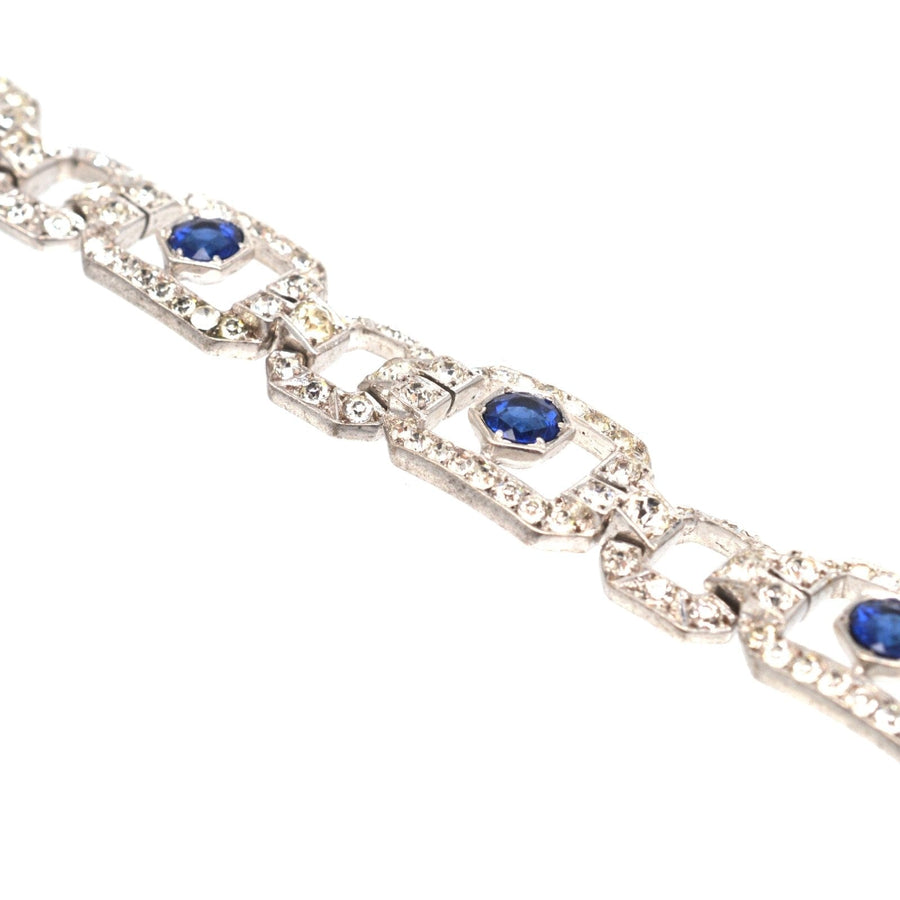 Art Deco silver bracelet with blue sapphire and white paste stones, by Knoll & Pregizer, showcasing intricate design.