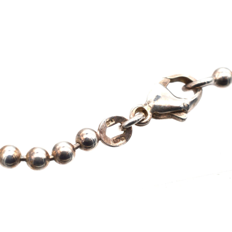 Close-up of a vintage sterling silver ball chain made by Binder FBM with a clasp, showcasing timeless design from the 1970s.